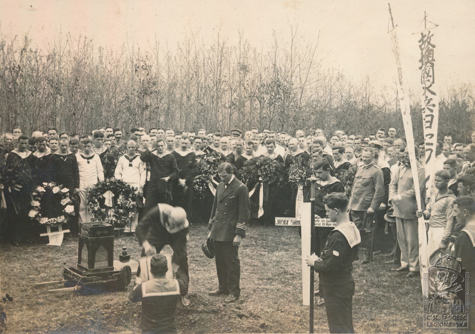 Ukládání urny s popel Josefa Šance do země.